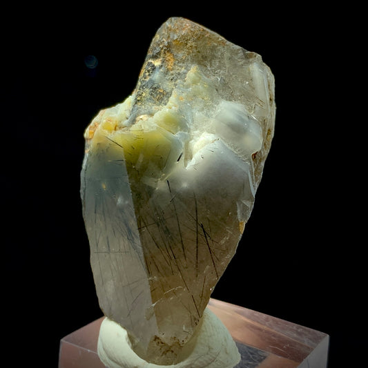 This is a stunning, high-grade Terminated Black Rutile Quartz Crystal specimen, weighing 168 carats. This piece is a rare find, sourced from the world-famous Zagi Mountain Mine, Pakistan, a locality renowned for producing exceptionally fine and highly sought-after Rutilated Quartz.
The crystal is characterized by its sharp, natural termination and excellent clarity, allowing full view of the dense, needle-like Black Rutile inclusions. The Rutile appears as dramatic, black filaments frozen within the clear