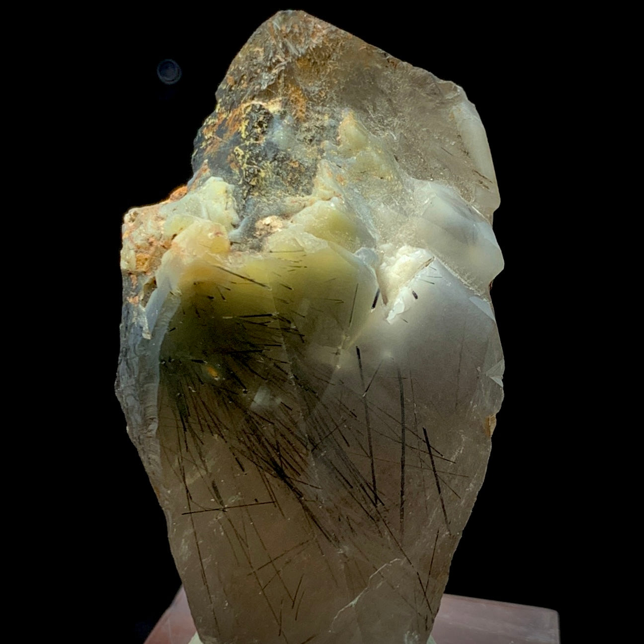 This is a stunning, high-grade Terminated Black Rutile Quartz Crystal specimen, weighing 168 carats. This piece is a rare find, sourced from the world-famous Zagi Mountain Mine, Pakistan, a locality renowned for producing exceptionally fine and highly sought-after Rutilated Quartz.
The crystal is characterized by its sharp, natural termination and excellent clarity, allowing full view of the dense, needle-like Black Rutile inclusions. The Rutile appears as dramatic, black filaments frozen within the clear
