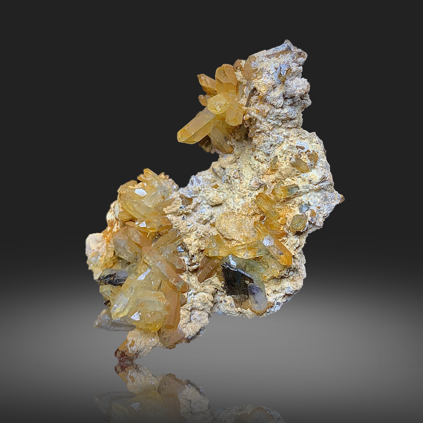 Mineral specimen with yellow and white crystals on a dark background
