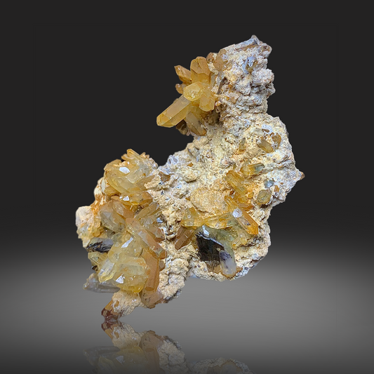 Mineral specimen with yellow and white crystals on a dark background