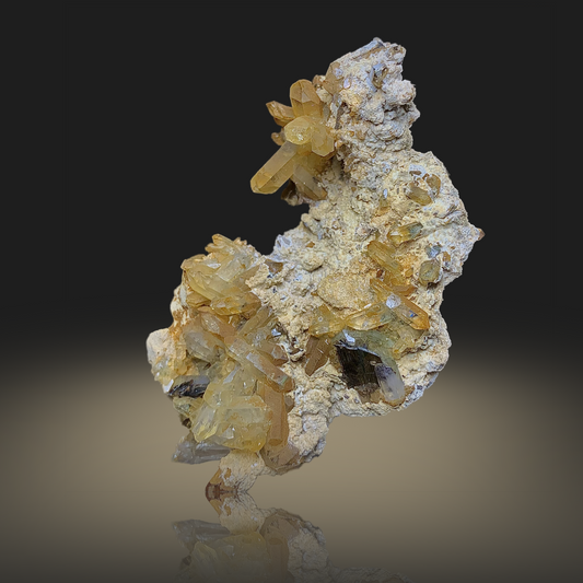Mineral specimen with yellow and white crystals on a gradient background