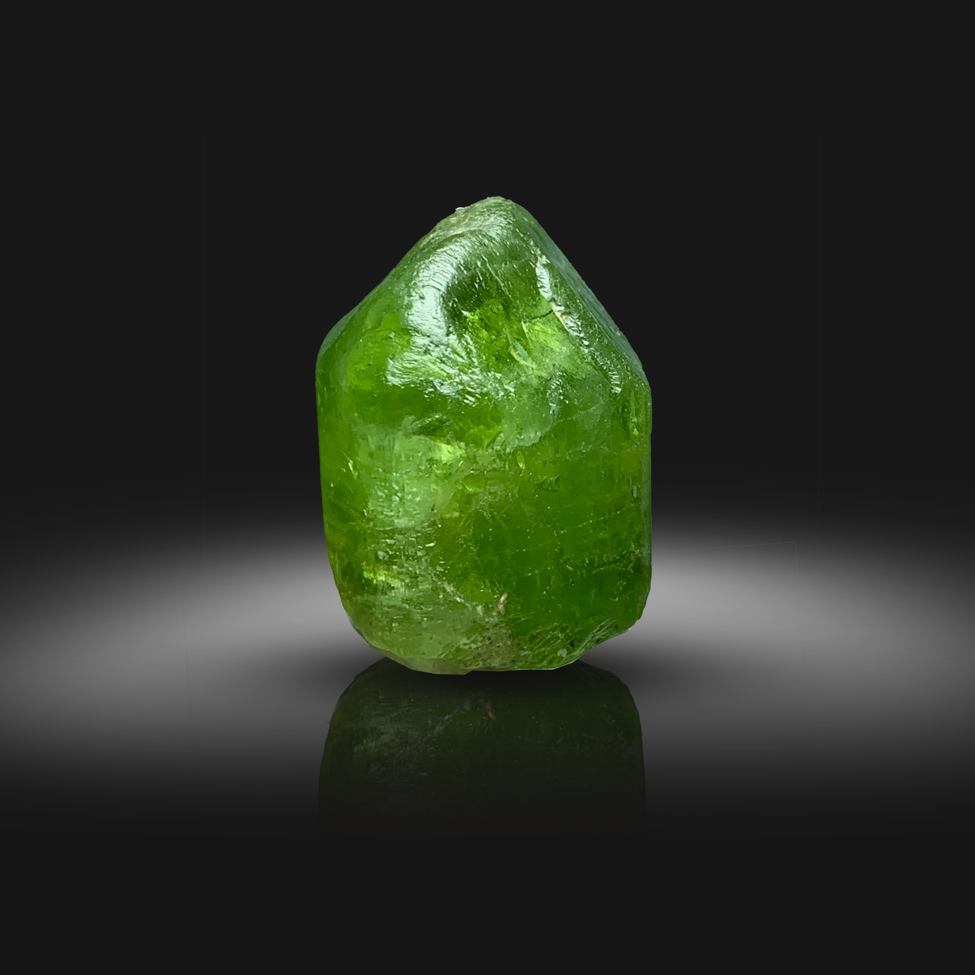 Green Peridot crystal from Front on a black background