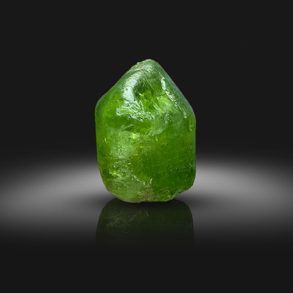 Green Peridot crystal from Front on a black background