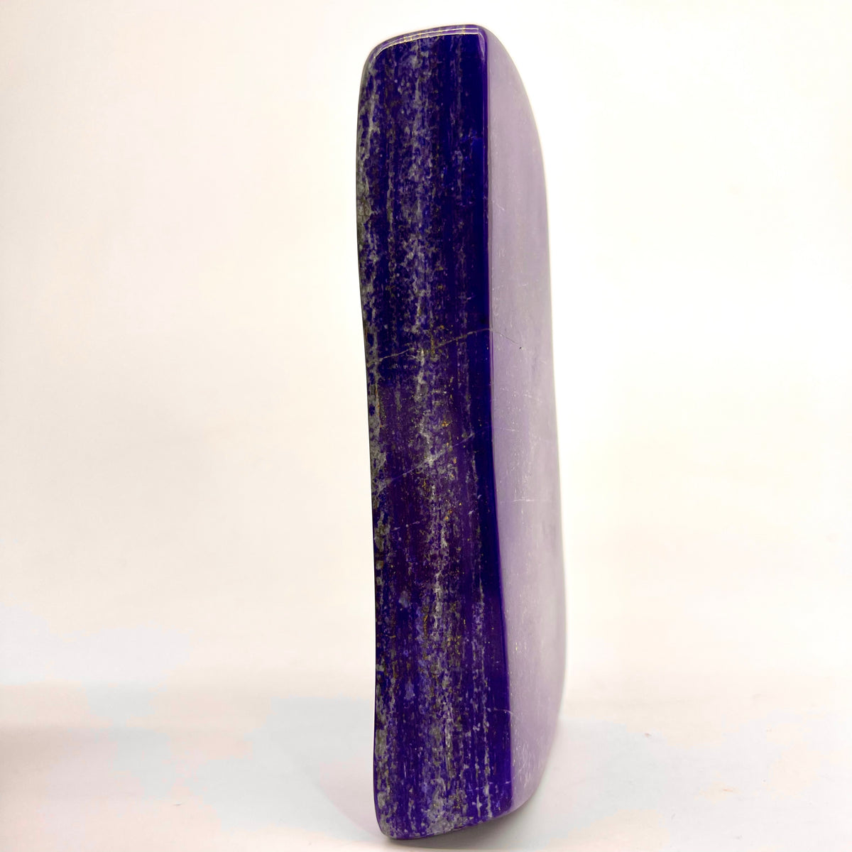 Close view of Pyrite veining on glossy surface
Reflective polish on deep ultramarine Lapis Lazuli