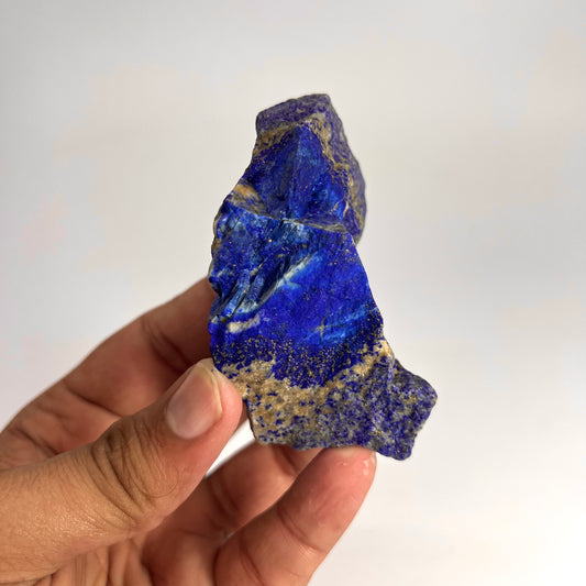 Deep blue Lazurite face with metallic gold streaks
Top-down view of raw blocky Lapis Lazuli