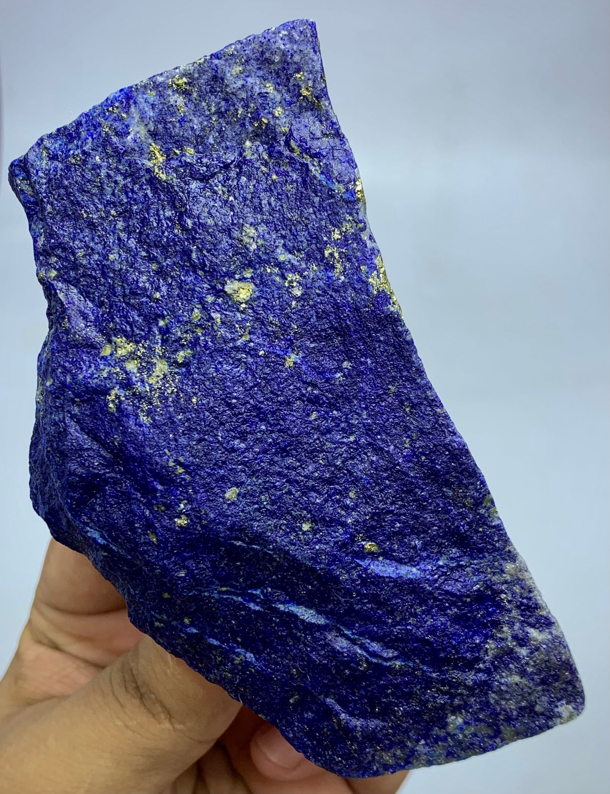 Afghan Lapis Lazuli, natural unpolished surface detail
Lapis Lazuli specimen displayed against neutral background
Lapis Lazuli rough stone, macro deta
