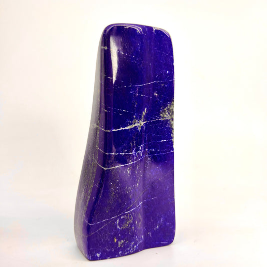 Glossy Lazurite finish with metallic gold clouds
Overhead view of polished elongated Lapis Lazuli