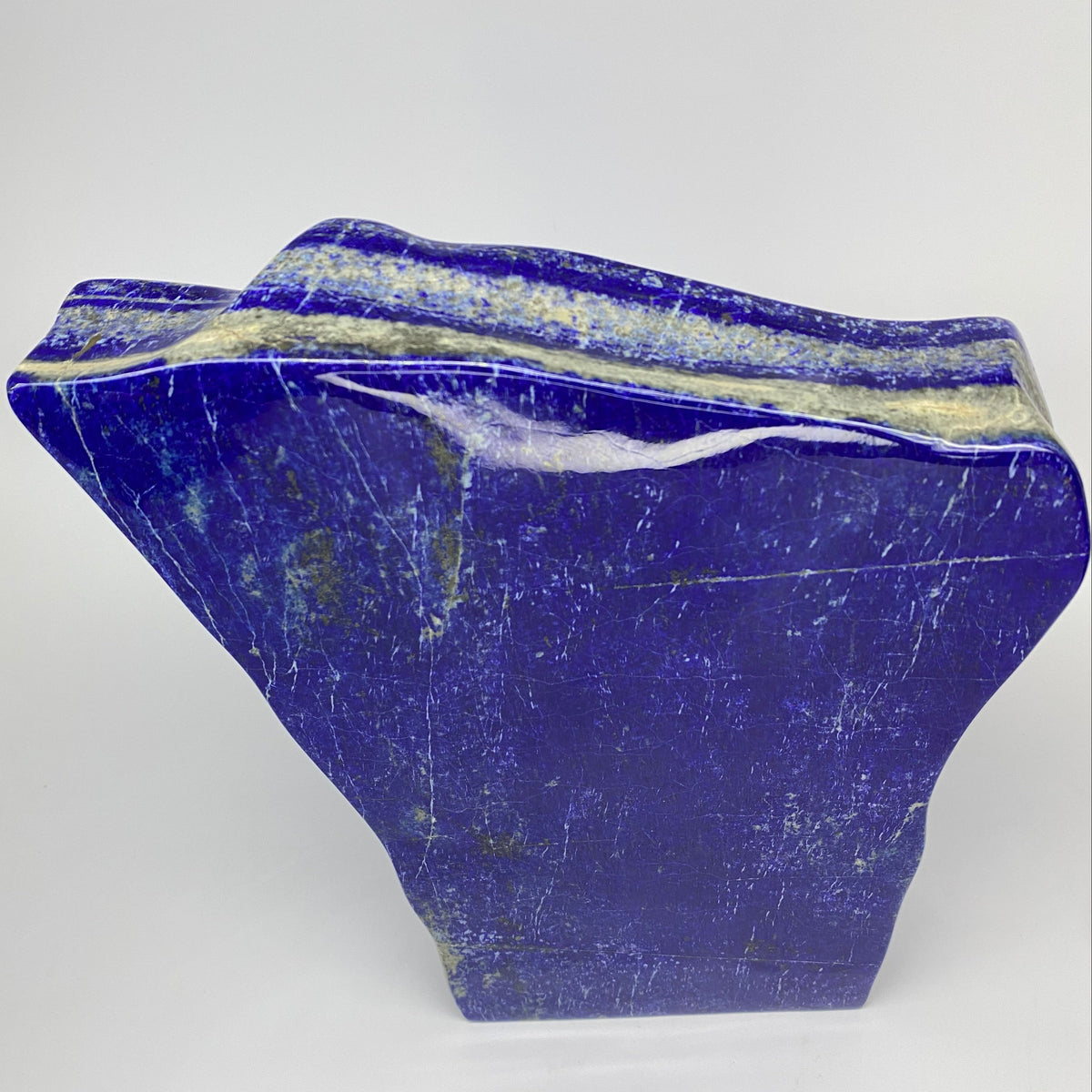 Golden Pyrite clouds across a polished blue face
Edge view showing 4.3 cm thickness of the block