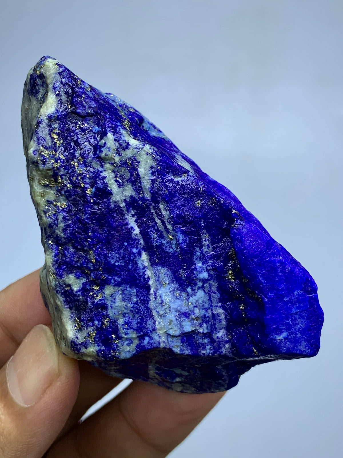 Thick Lapis Lazuli specimen, full piece overview
Detail shot of Lazurite blue coloring on rough specimen
Lapis Lazuli specimen displayed against neutral background
Lapis Lazuli rough stone, macro detail of matrix texture