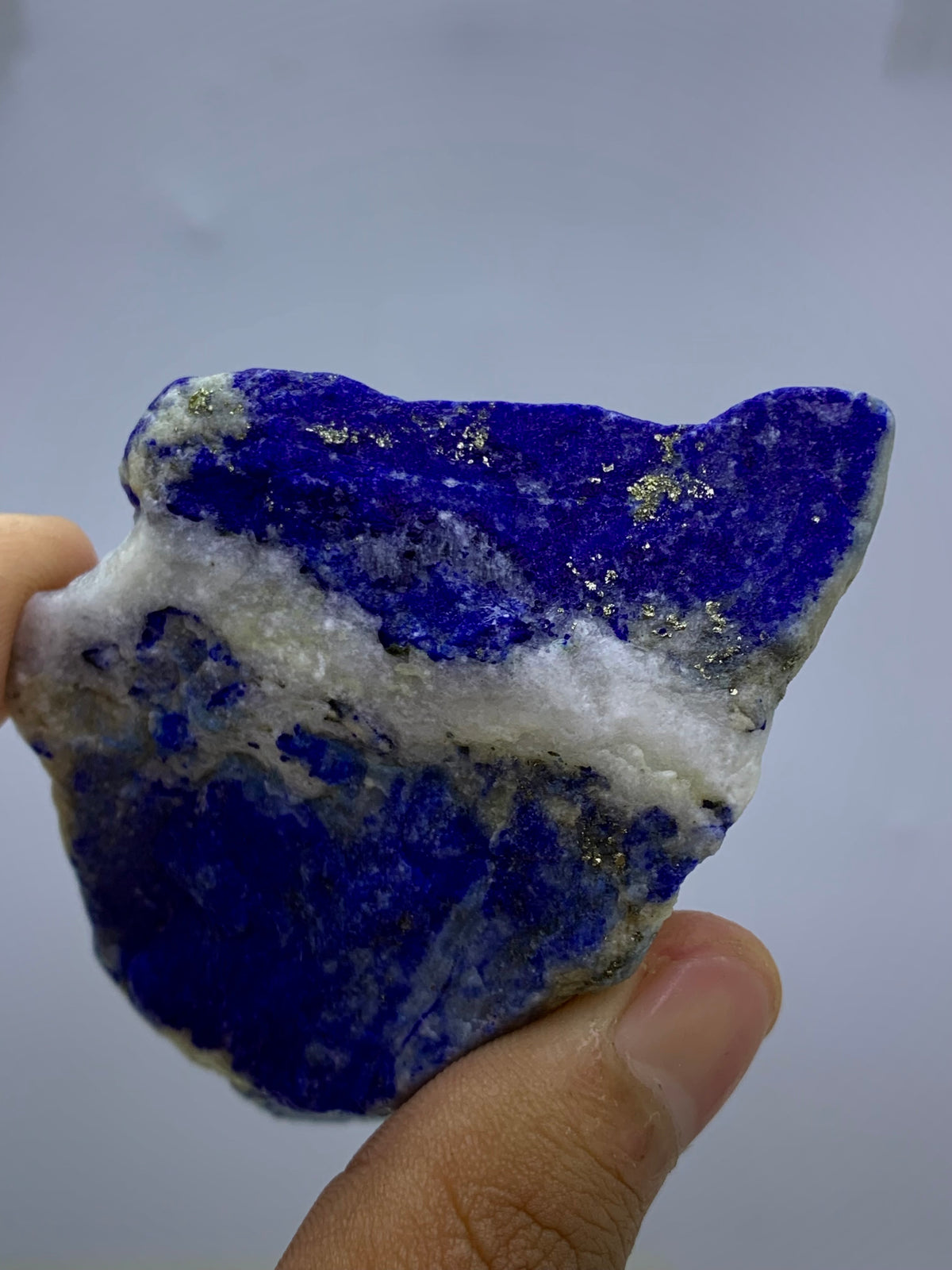 Close-up view of Pyrite veins on Lapis Lazuli specimen
Badakhshan Lapis Lazuli specimen, natural rough texture
Lapis Lazuli specimen, angled view highlighting depth
Thick Lapis Lazuli specimen, full piece overview
Detail shot of royal blue coloring on rough specimen