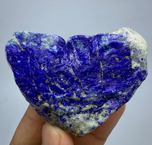 Heart-shaped lapis lazuli crystal with deep blue and purple coloration & gold pyrite flecks