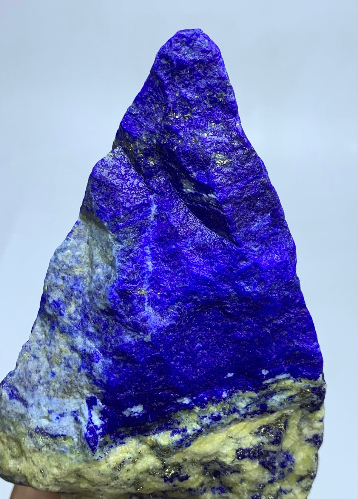Unpolished Afghan Lapis Lazuli, spiky surface
Full shot of elongated ridged Lapis Lazuli
Textured Lapis Lazuli specimen on plain backdrop