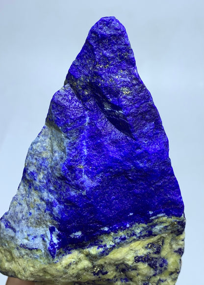 Unpolished Afghan Lapis Lazuli, spiky surface
Full shot of elongated ridged Lapis Lazuli
Textured Lapis Lazuli specimen on plain backdrop